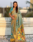 Woman wearing a traditional saree with floral patterns outdoors.