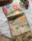 Beige scarf with colorful floral patterns on a fluffy white surface.