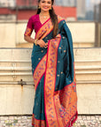 Woman wearing a blue and pink saree with a blurred background