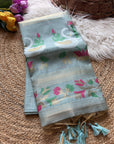 Light blue fabric with floral patterns on a textured surface