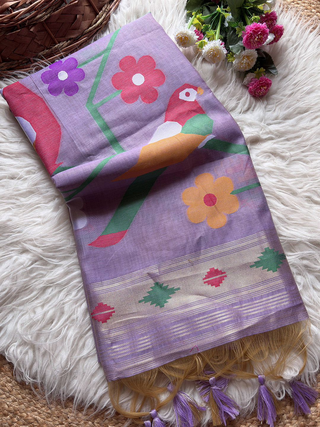 Colorful towel with floral and bird design on a textured surface