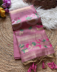 Pink saree with floral patterns on a textured surface