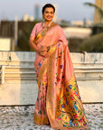 Woman wearing a traditional saree with a colorful design outdoors.