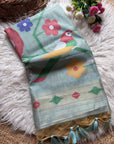 Decorative fabric with parrot and flower patterns on a fluffy white surface.