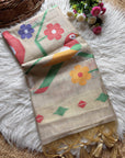 Decorative scarf with colorful floral and bird patterns on a textured surface.