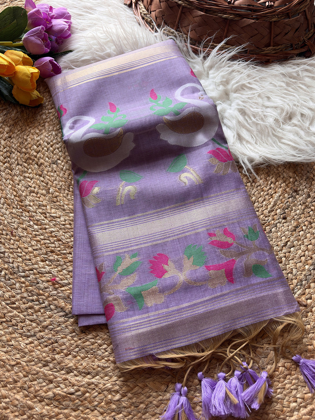 Folded purple fabric with floral patterns on a textured surface