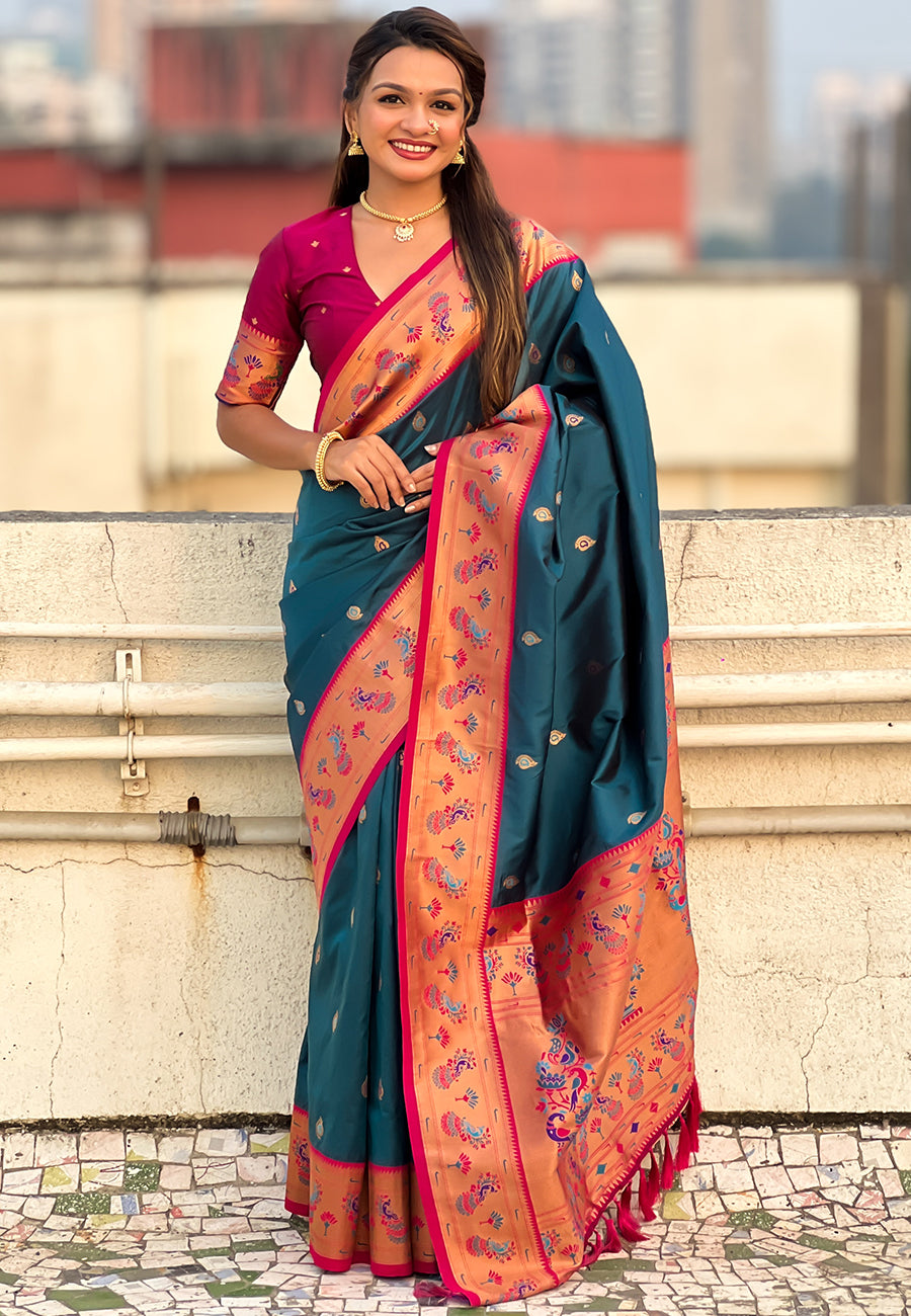 Woman wearing a blue and pink saree with a blurred background