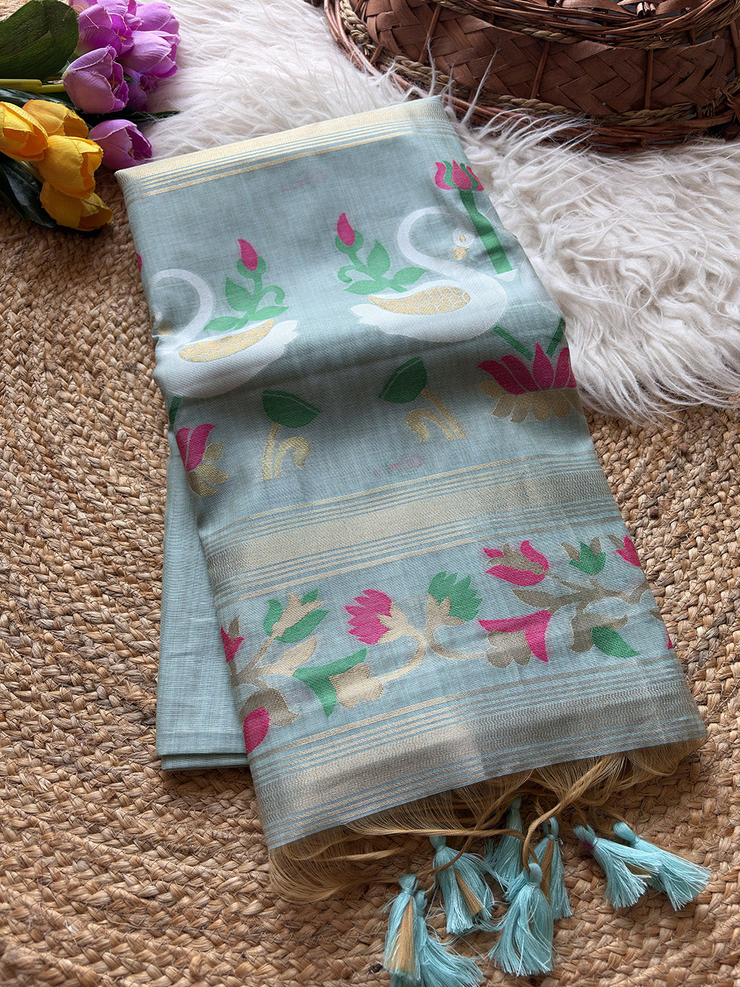 Light blue fabric with floral patterns on a textured surface