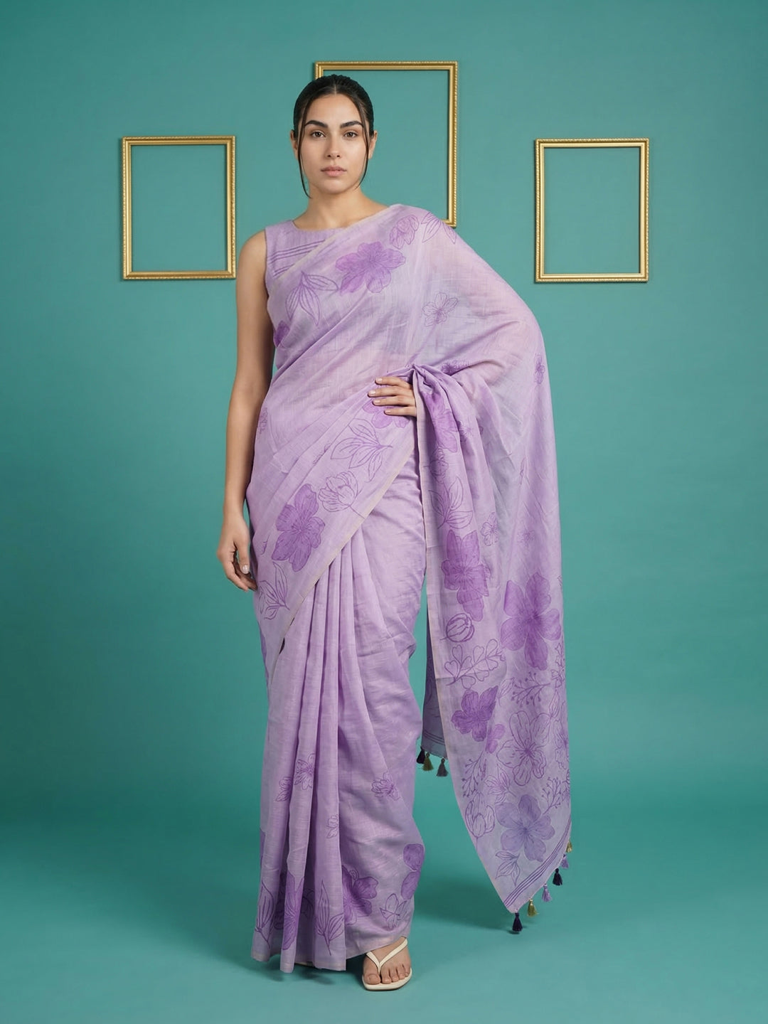 Woman wearing a purple saree with a floral pattern on a teal background