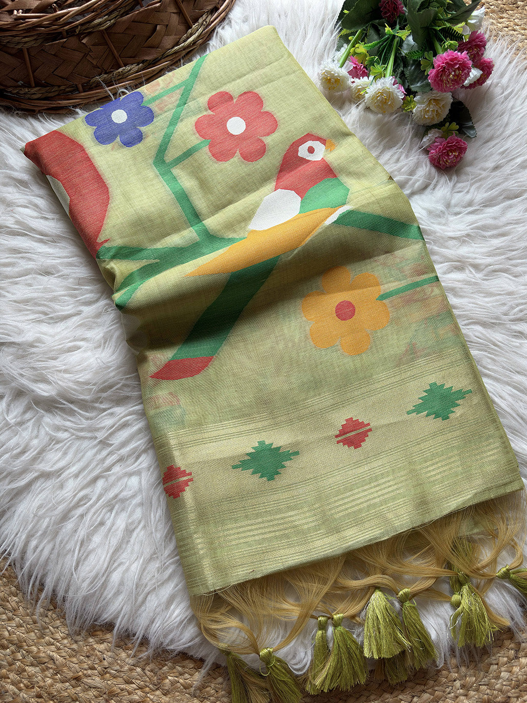 Colorful scarf with floral patterns and tassels on a textured surface